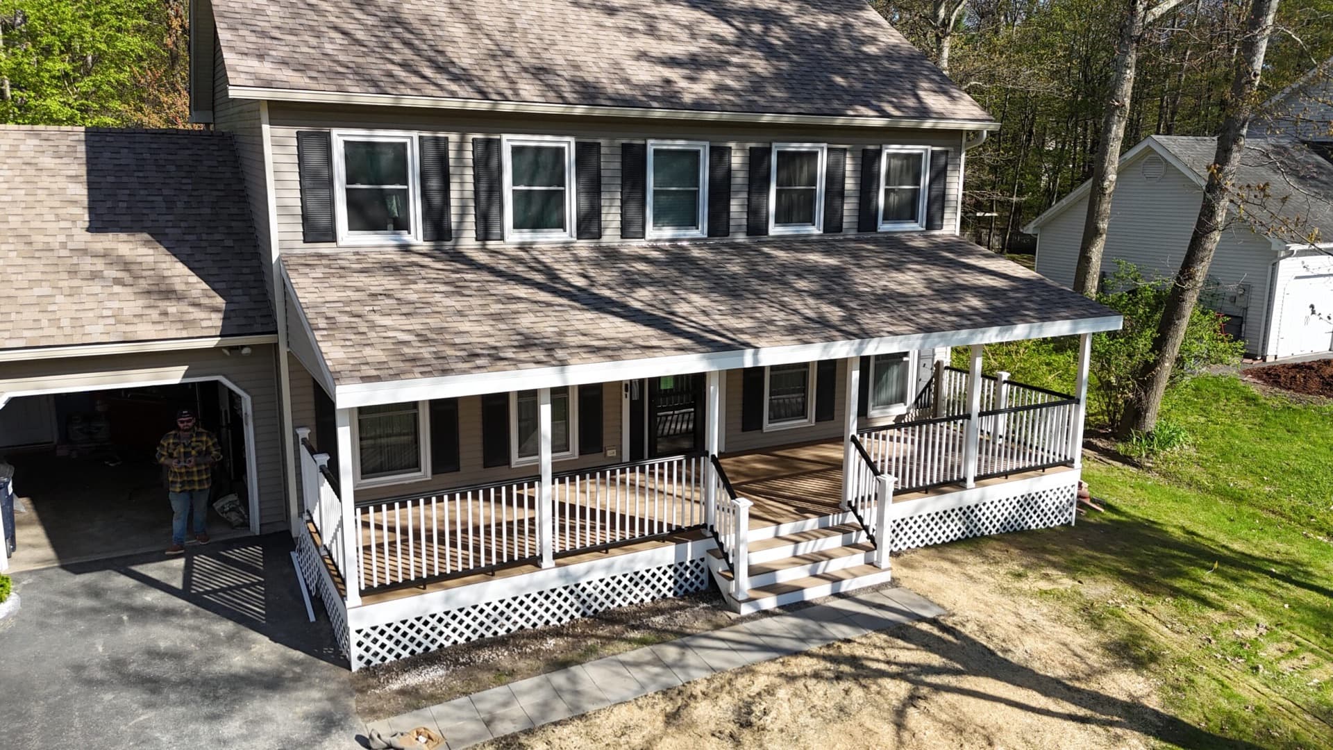 Aerial view of a completed porch and roof project on a Vermont home