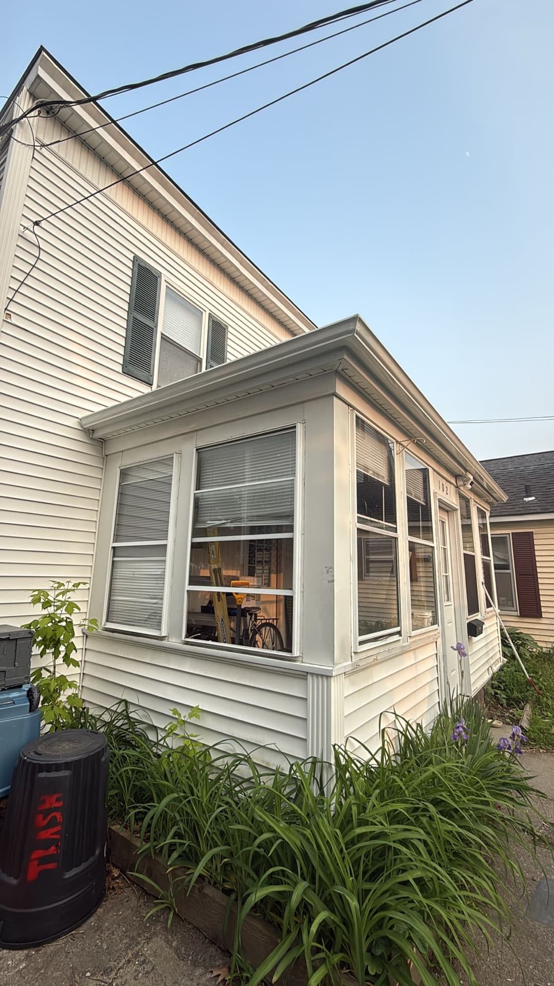 Enclosed porch exterior with fresh trim and siding details