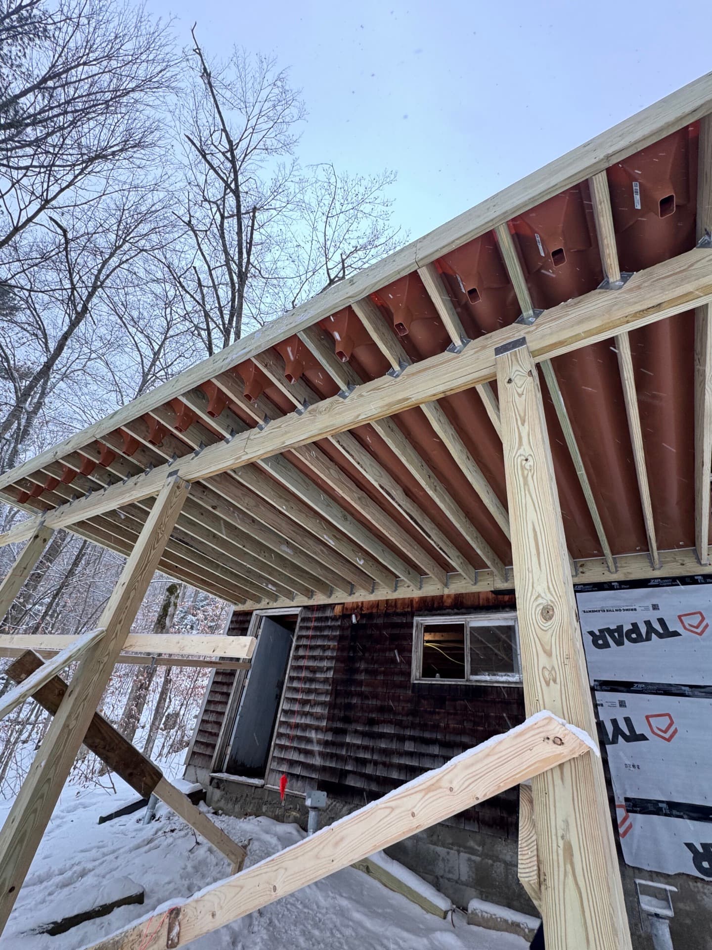 Porch roof framing with engineered venting on a home addition