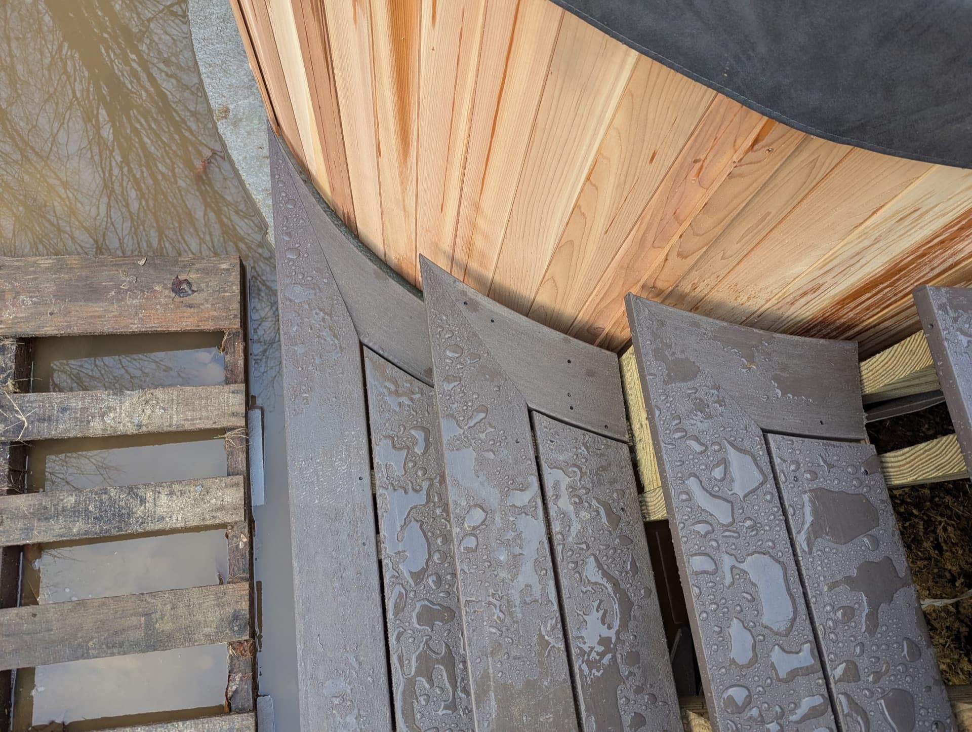 Curved cedar hot tub surround and composite deck detail